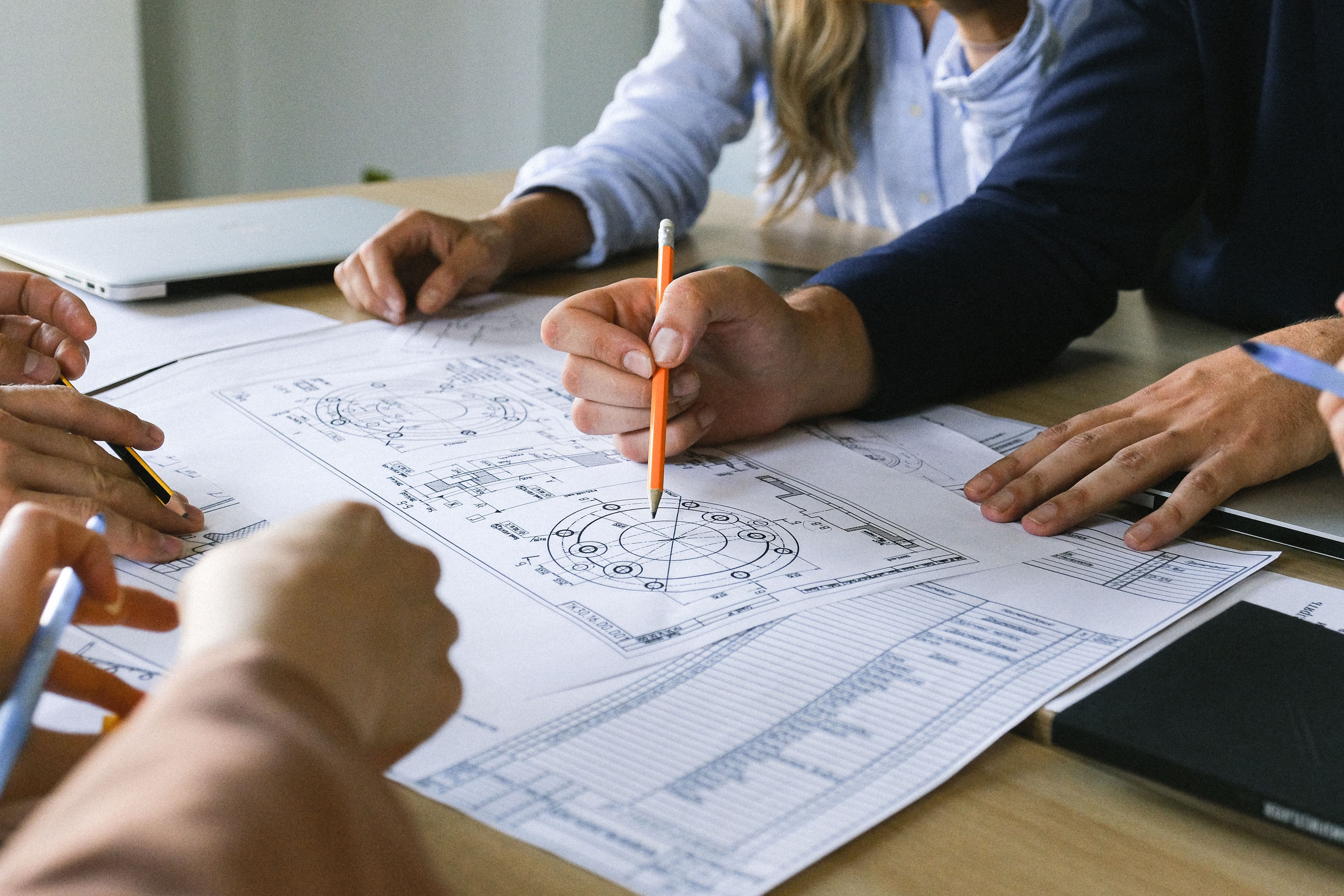 Engineering team reviewing transformer design drawings
